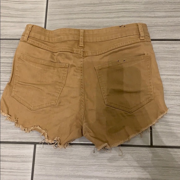 Tan colored mid rise jean shorts. - Picture 2 of 3